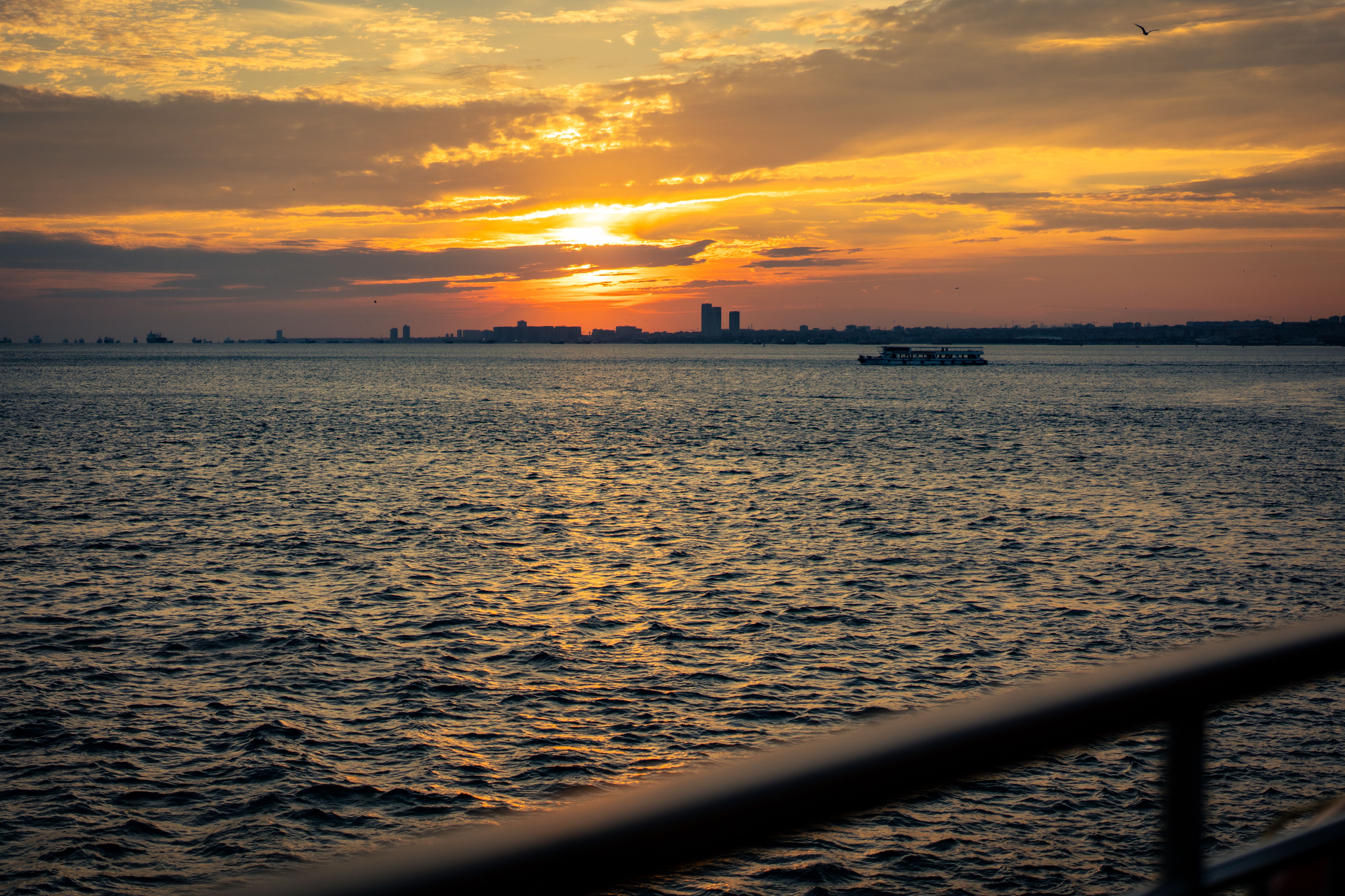 Scenic Sunset Over Water with City Skyline · Free Stock Photo