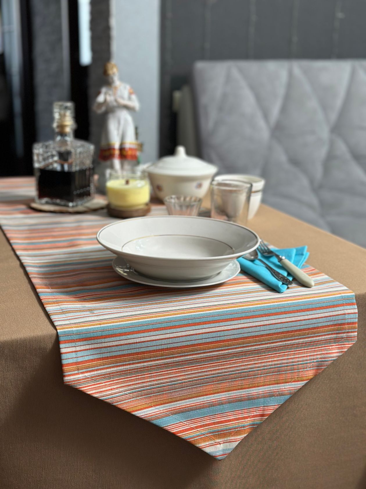 how to style a table runner: an elegant table setup with a striped runner and dishware