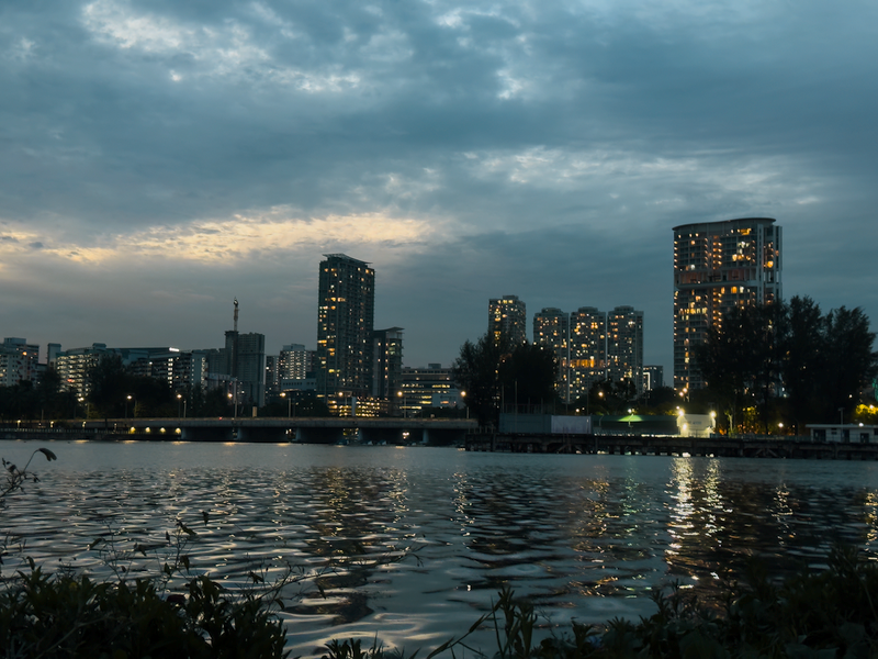 City skyline at twilight reflected on calm water — photo by Shlok Rana on Pexels
