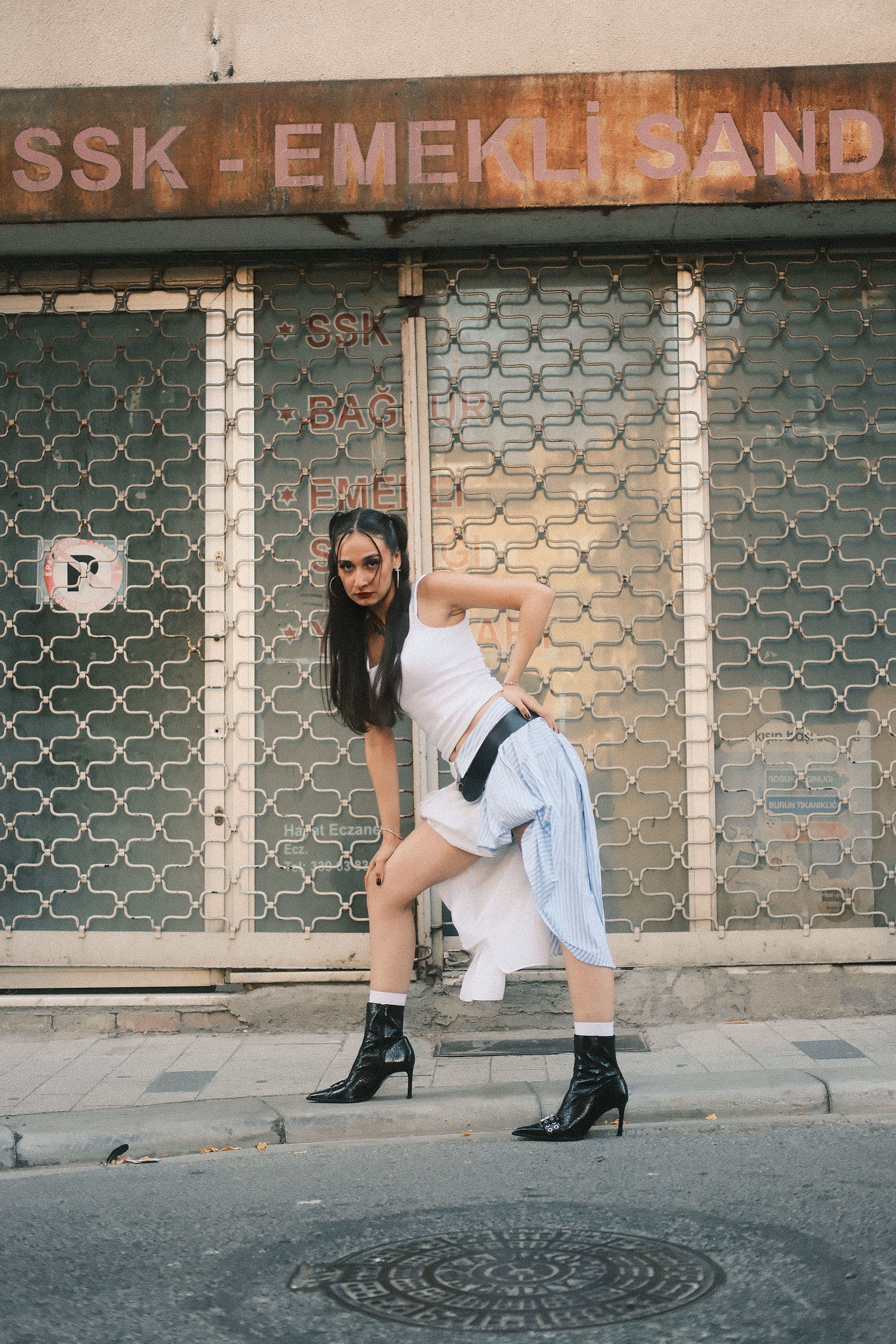 Stylish Woman Posing in Urban Street Setting · Free Stock Photo
