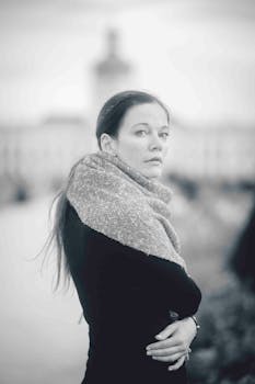 Black and white portrait of a woman in front of Charlottenburg Palace, Berlin.