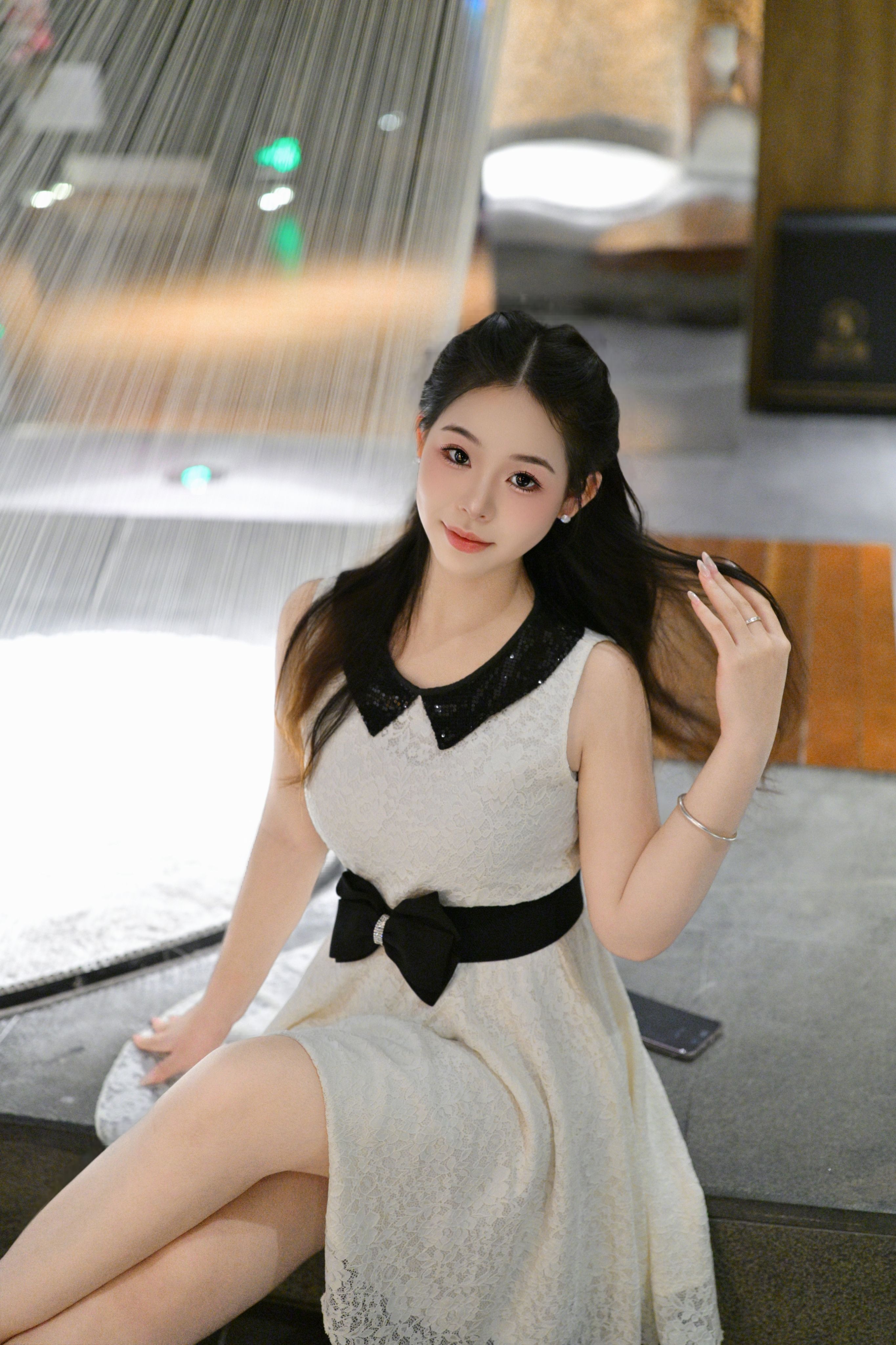 Elegant Woman Posing Indoors in Fashionable Dress · Free Stock Photo