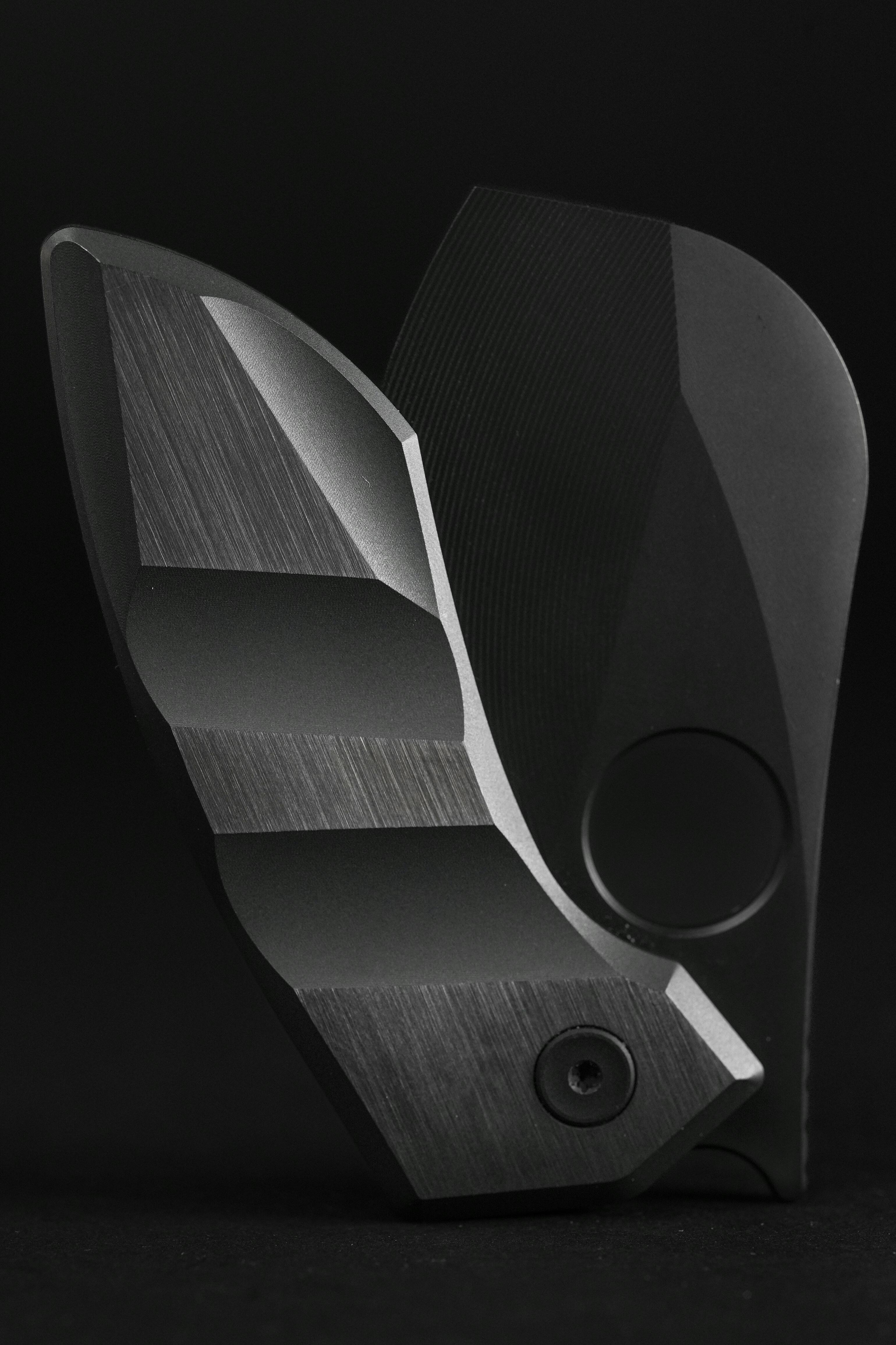 Close-up of a futuristic, geometric metal object with sleek design.