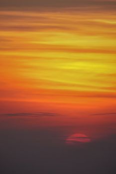 Capture of a vibrant sunset sky with bold reds, oranges, and yellows creating a dramatic and breathtaking view.