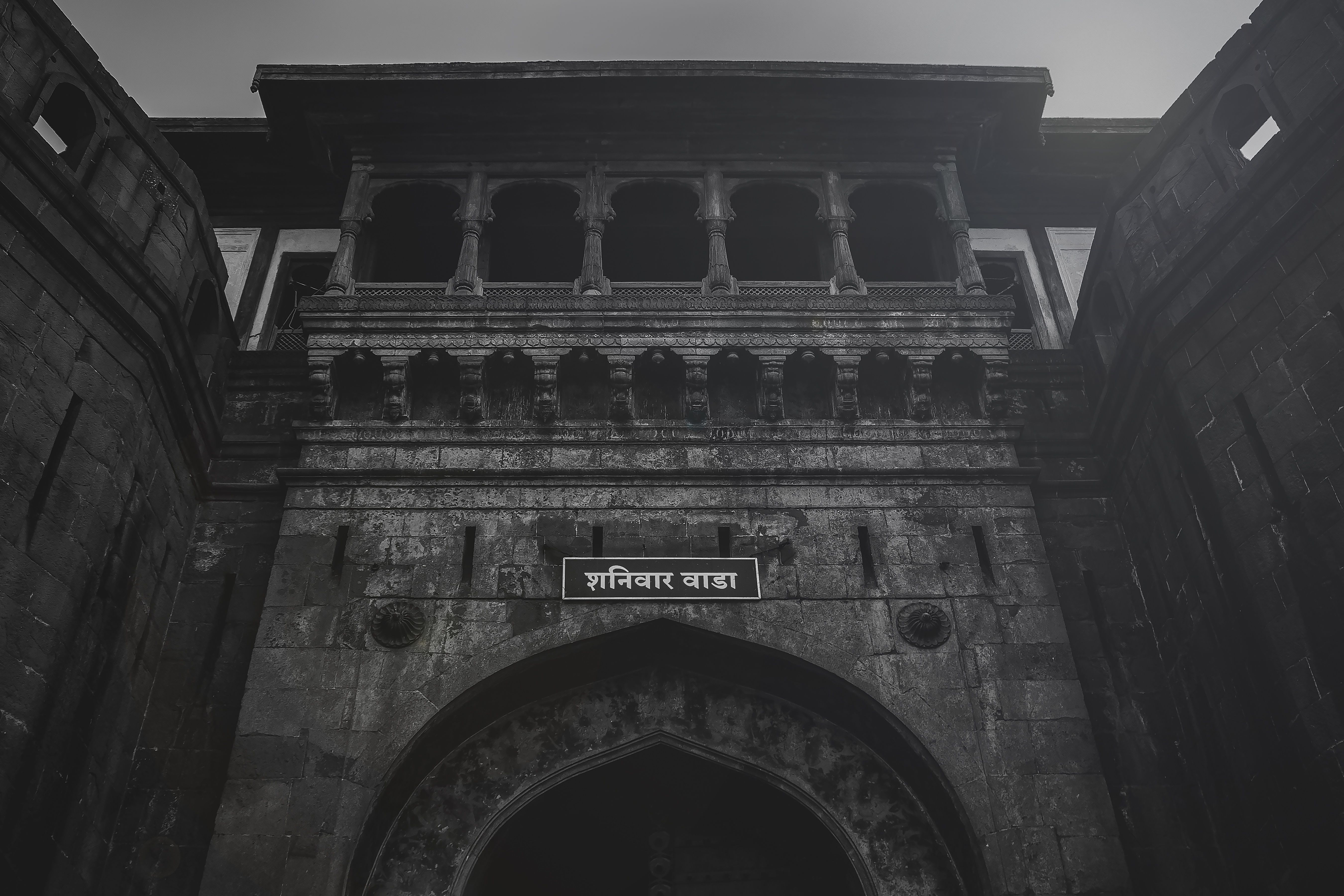 A dramatic view of the historic Shaniwar Wada Fort in Pune, showcasing its stunning architectural details.