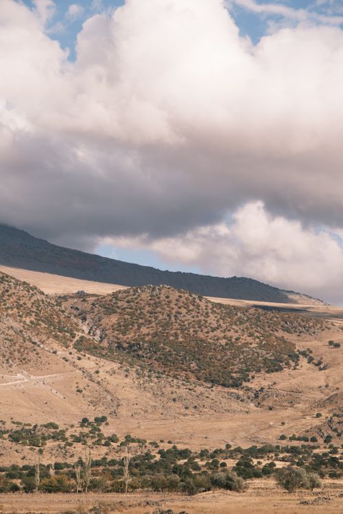 Free Beautiful view of a dry mountainous landscape under cloudy skies, showcasing natural beauty and serenity. Stock Photo