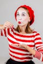 Mime Artist in Red and White Costume Performing