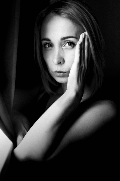 Free Artistic black and white portrait of a thoughtful woman gazing at the camera. Stock Photo