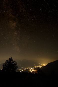 Captivating view of a star-filled night sky over Inn Valley, Kramsach, Austria offering serene natural beauty.