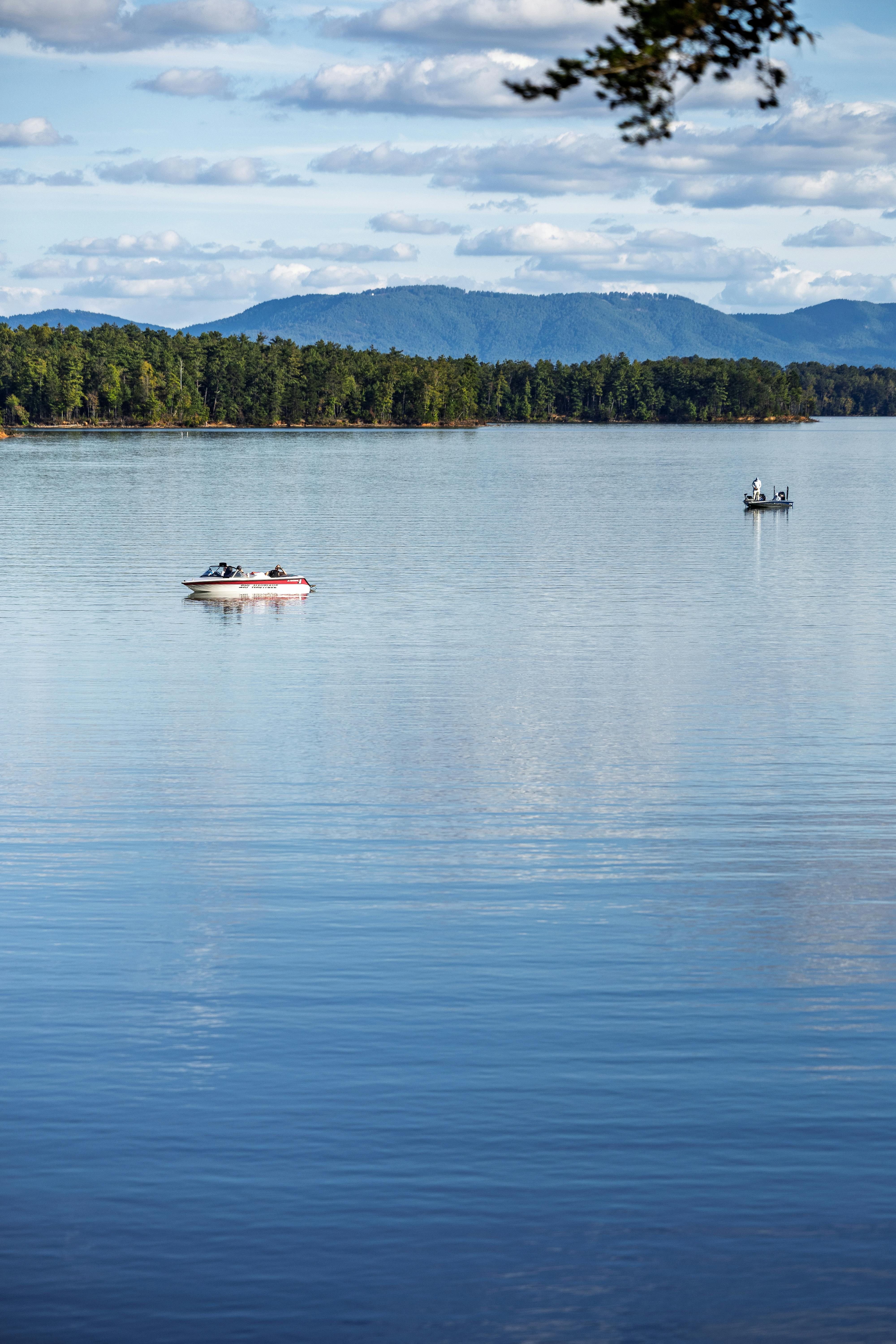 两艘船在北卡罗来纳州一个平静的湖面上，背景是森林茂密的山脉