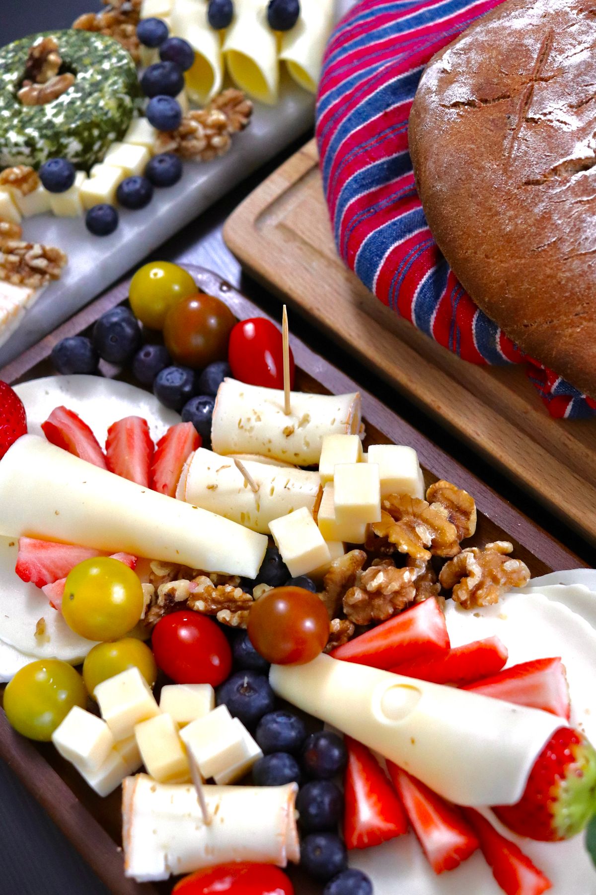 Cheese and fruit platter with various cheeses and berries