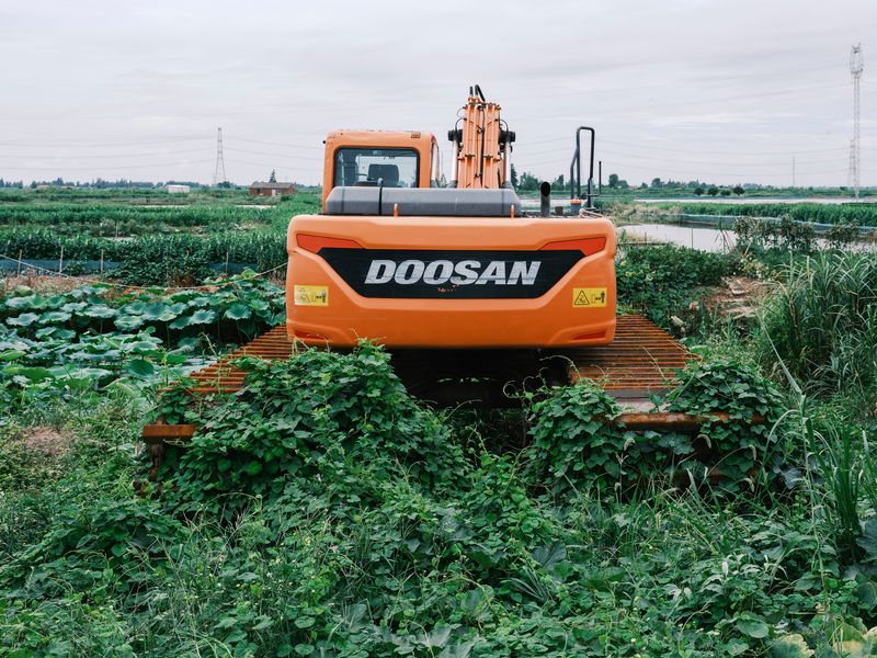 Forestry mulching equipment working across a rural field near Mantachie, Mississippi