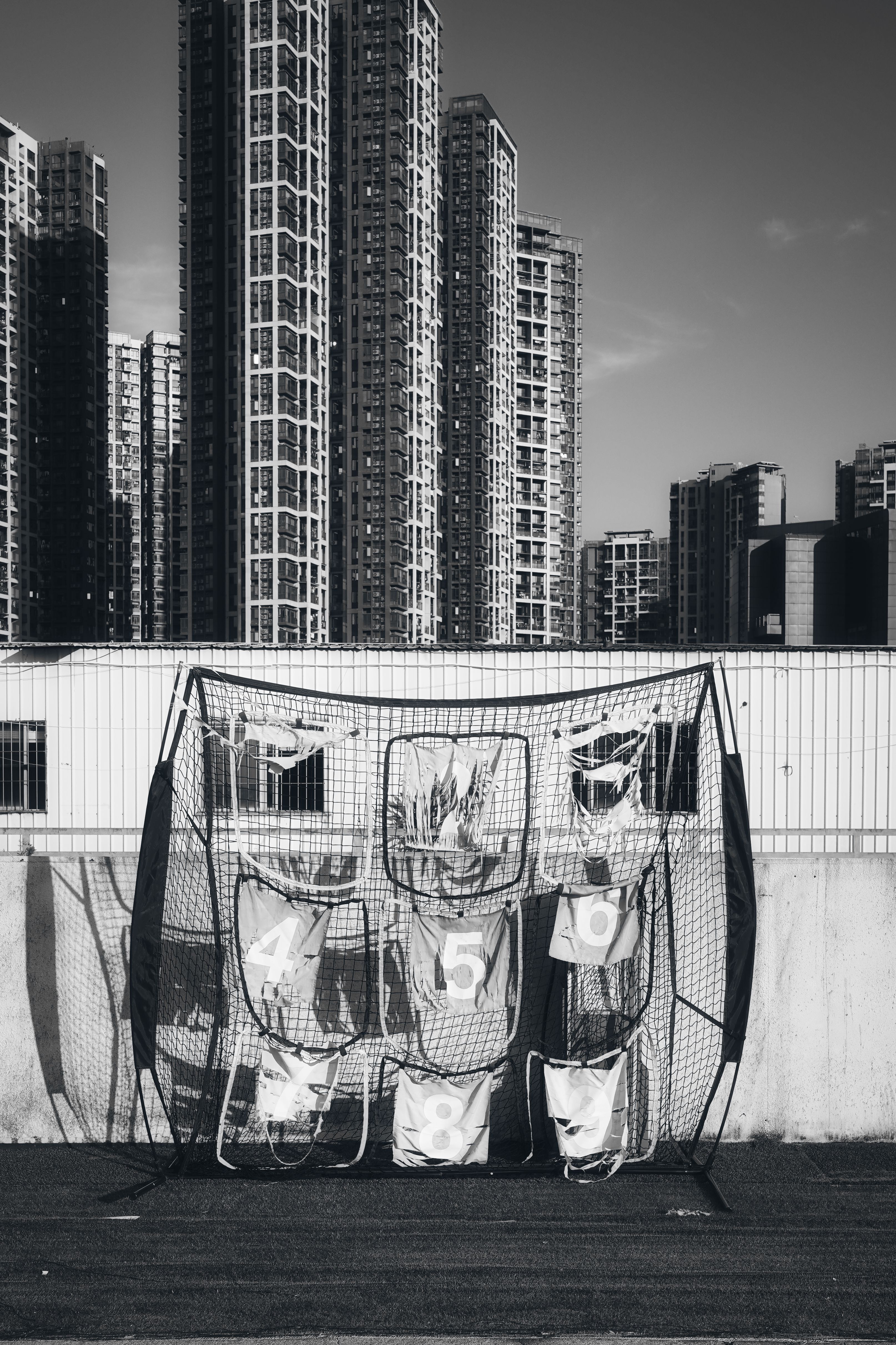 Urban Basketball Practice with High-Rise Backdrop · Free Stock Photo