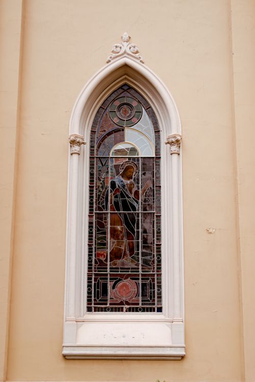 Free Close-up of a stained glass window on a historic basilica, showcasing intricate religious artistry. Stock Photo