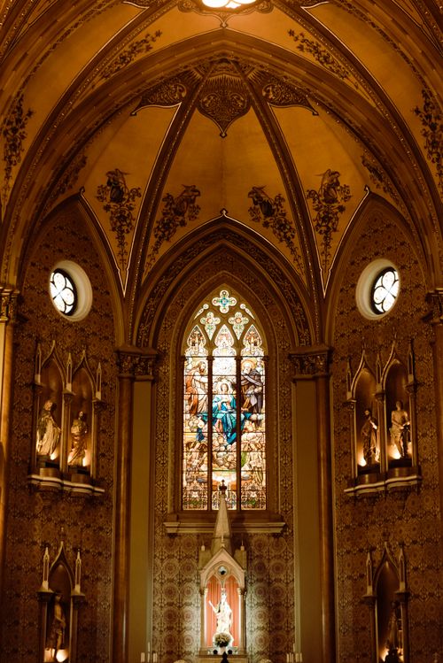Free Majestic interior of a gothic basilica featuring ornate stained glass and intricate arches. Stock Photo
