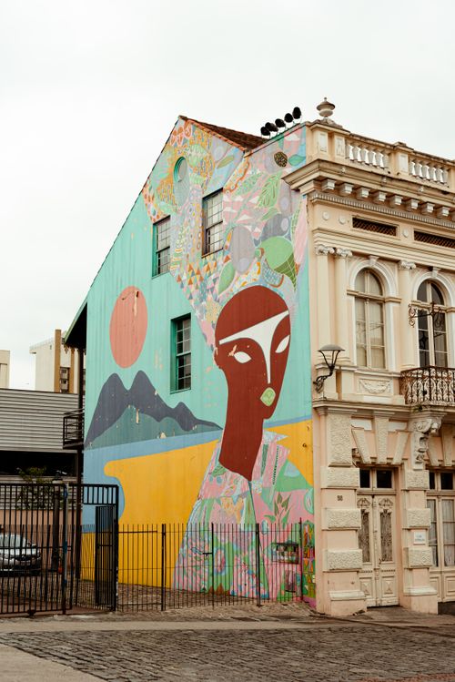 Free Vibrant mural on a building in Curitiba showcasing artistic street art with cultural motifs. Stock Photo