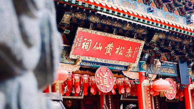 Explore the vibrant architecture and red lanterns at Hong Kong's Wong Tai Sin Temple.