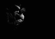 Moody Black and White Man Lighting Cigarette