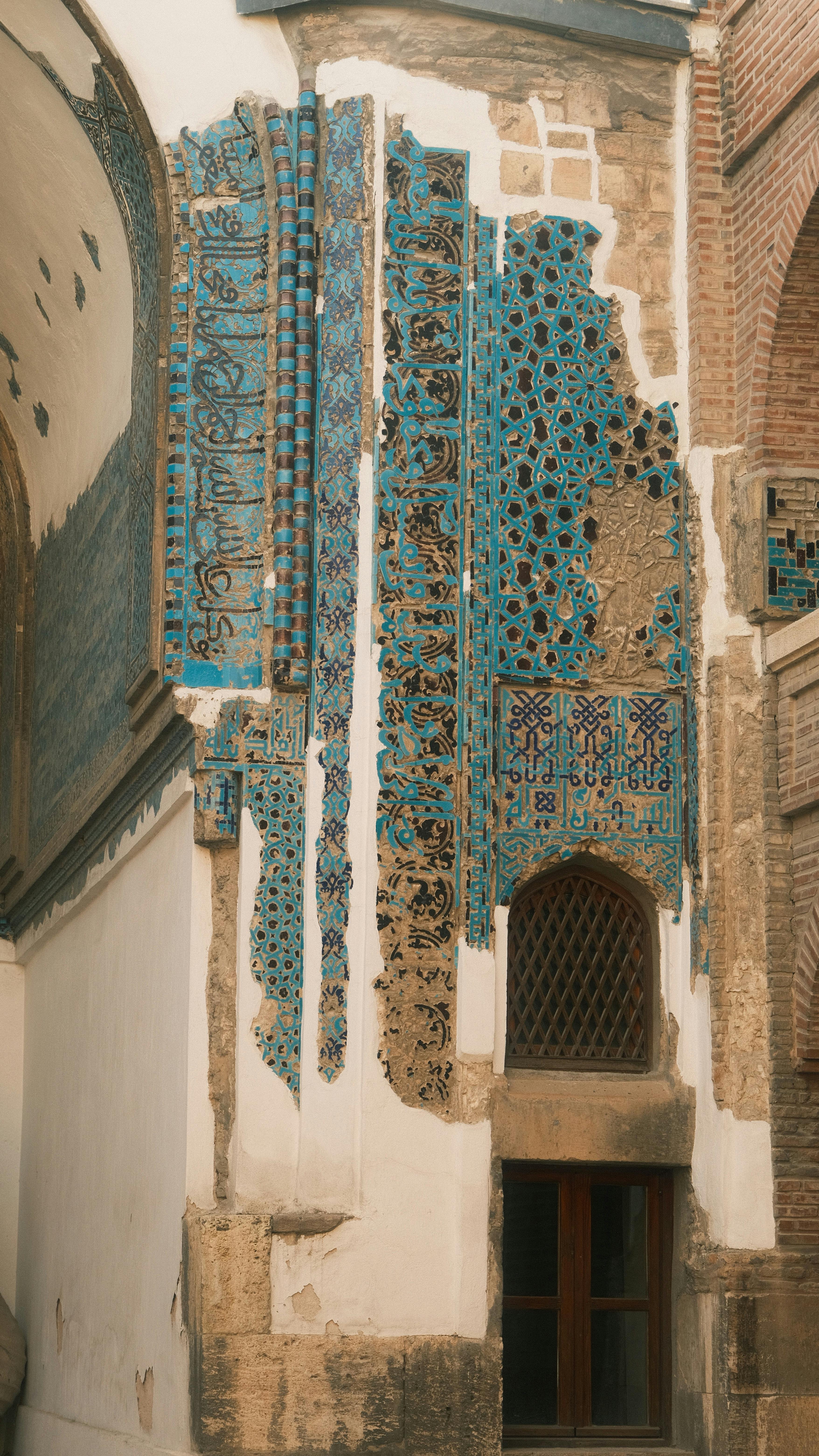 Intricate tilework and historic architectural details in Middle Eastern building.
