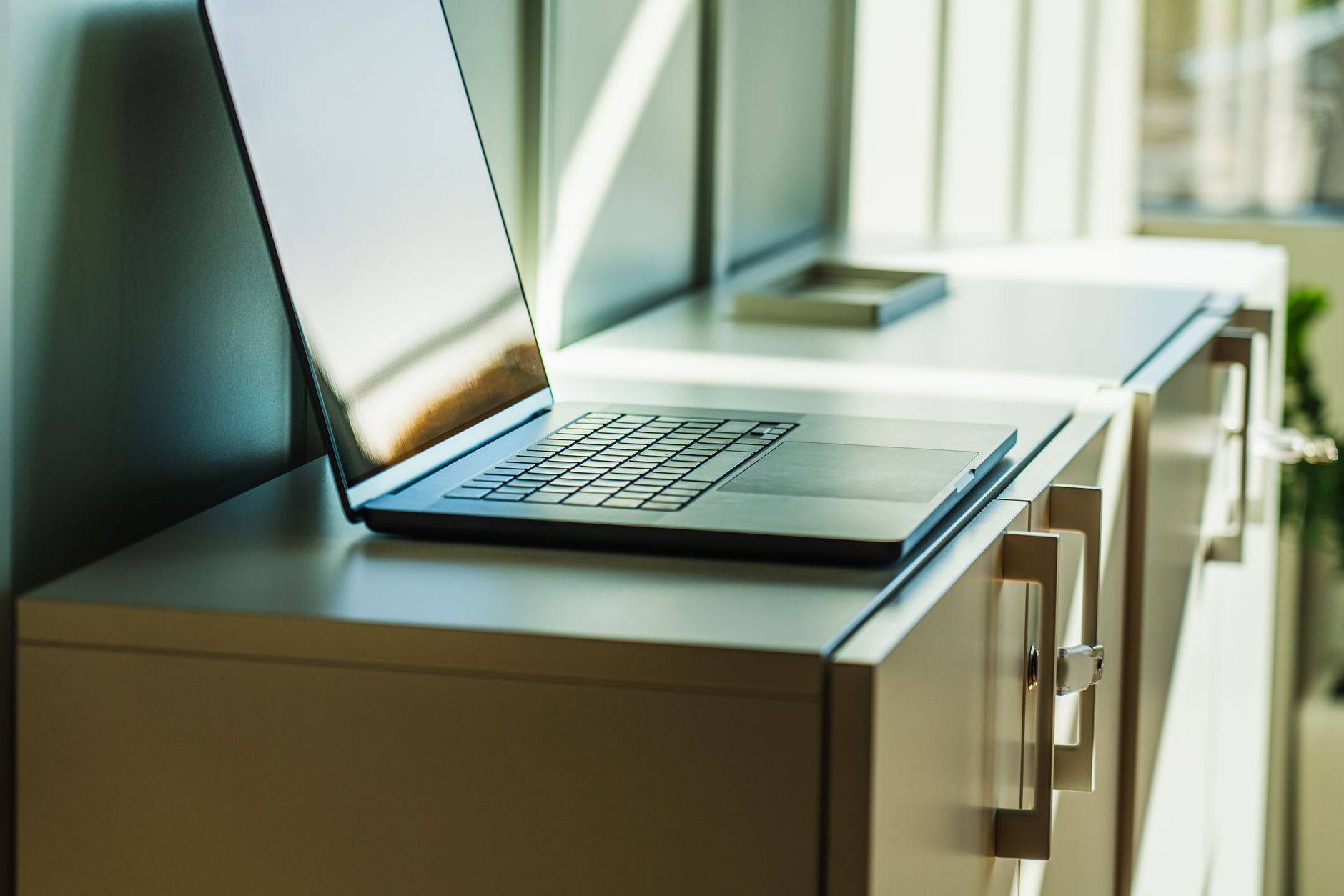 A Windows laptop showing SHA-256 file verification beside a printed software publisher certificate