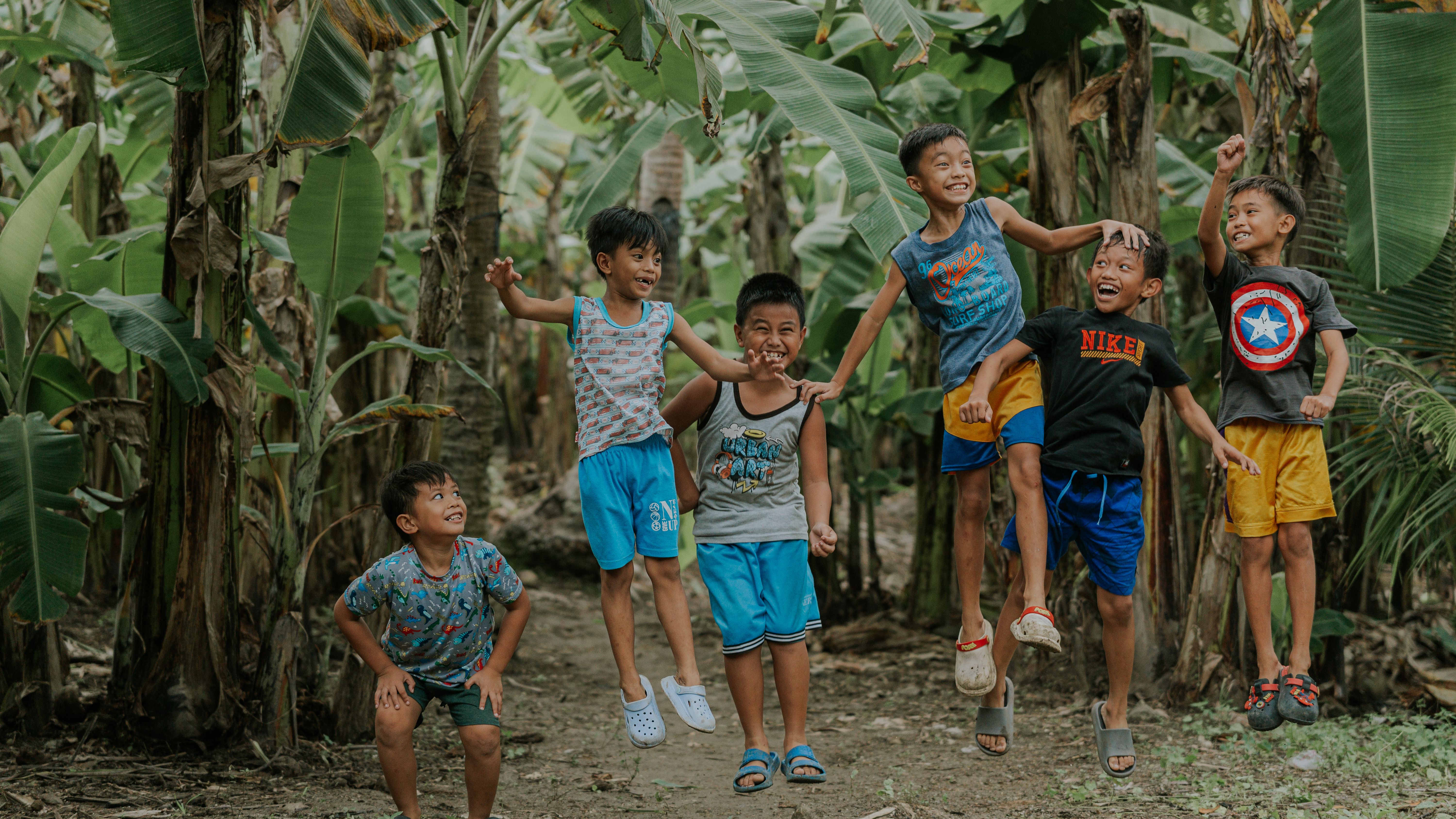 Happy Kids Playing in Lush Banana Plantation · Free Stock Photo