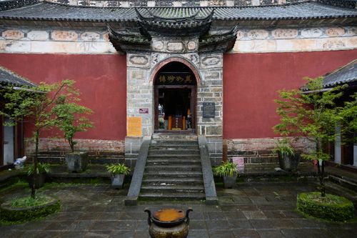 Free Entrance of a traditional Chinese temple showcasing intricate stone architecture and decorative plants. Stock Photo