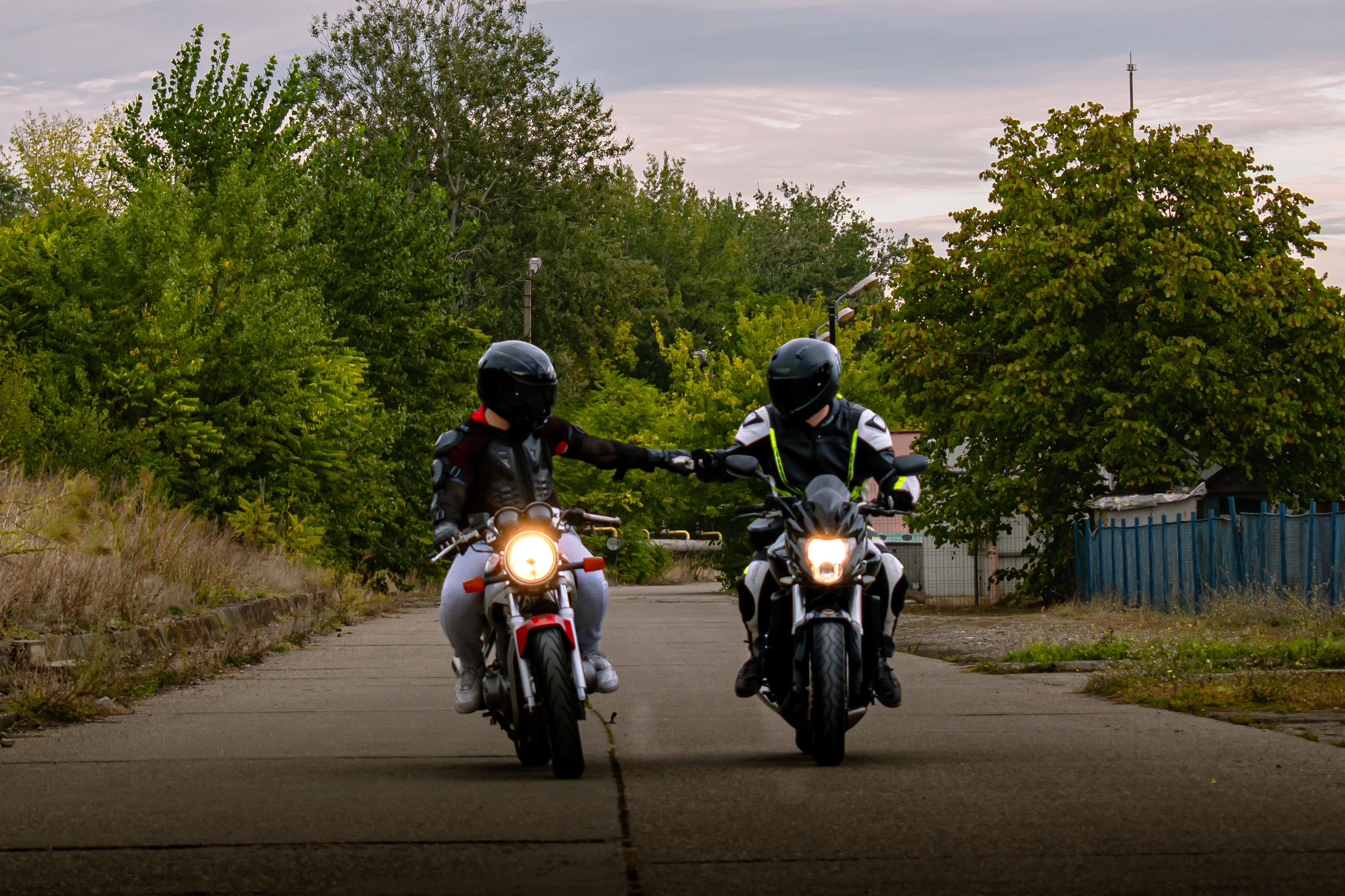 Two Motorcyclists Shaking Hands on Country Road · Free Stock Photo