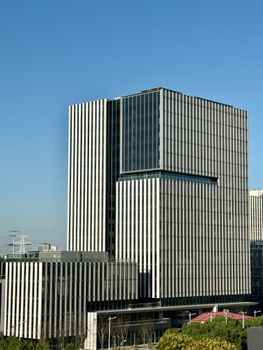 A striking modern office building against the clear blue sky in Shanghai.
