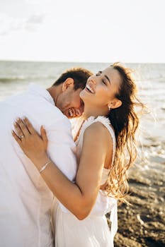 Happy couple enjoying a romantic moment on a sunny beach in Antalya, Türkiye.