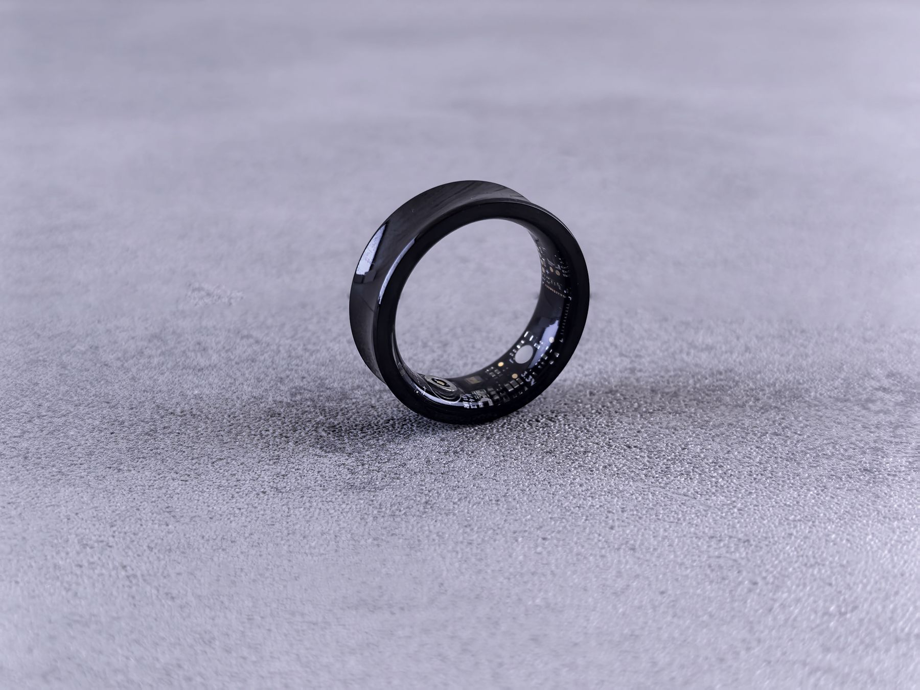 Black smart ring with visible electronic circuitry