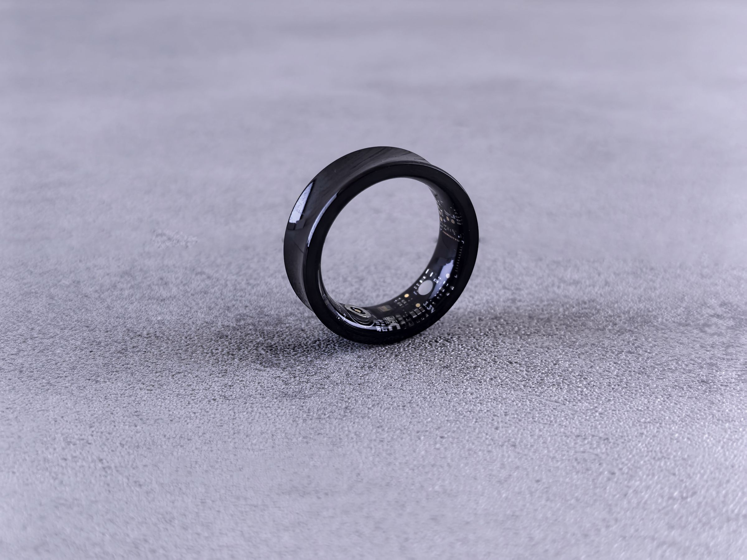 A matte sensor ring standing upright on a soft grey studio surface. Photo by Andrey Matveev on Pexels.