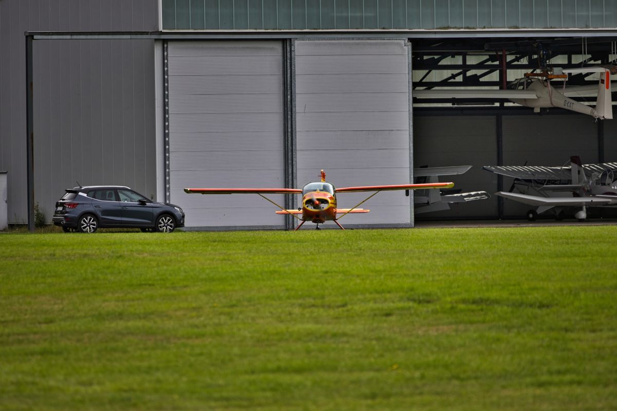 Piper Super Cub on a grass airstrip with open sky background