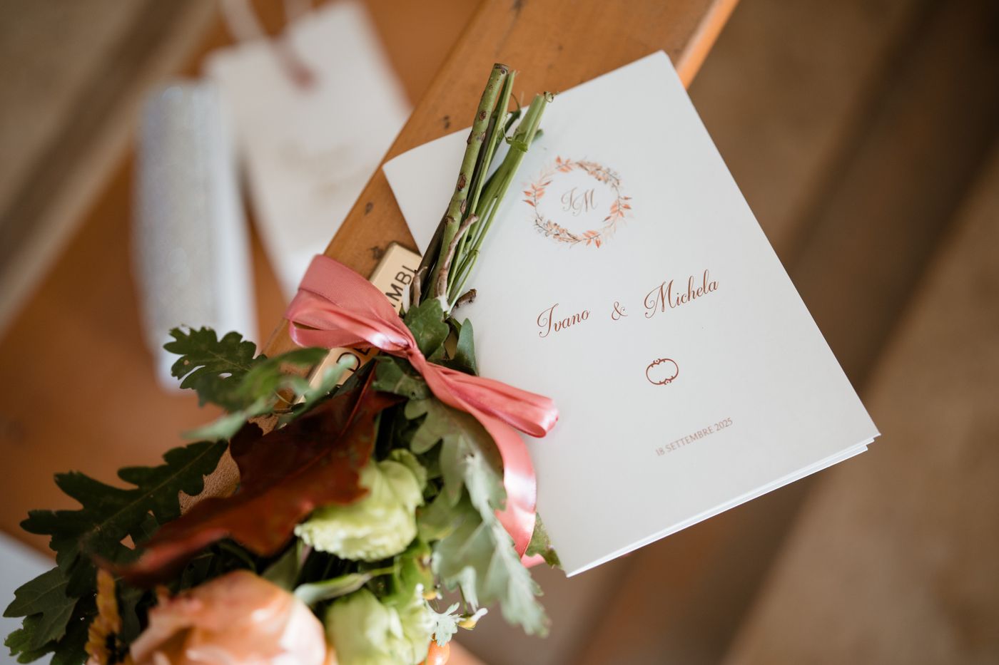 Invitation card beside a floral arrangement