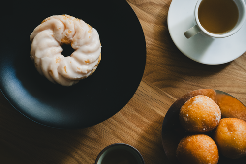 Free Overhead view of pastries and coffee on a wooden table, creating a cozy and inviting setting. Stock Photo