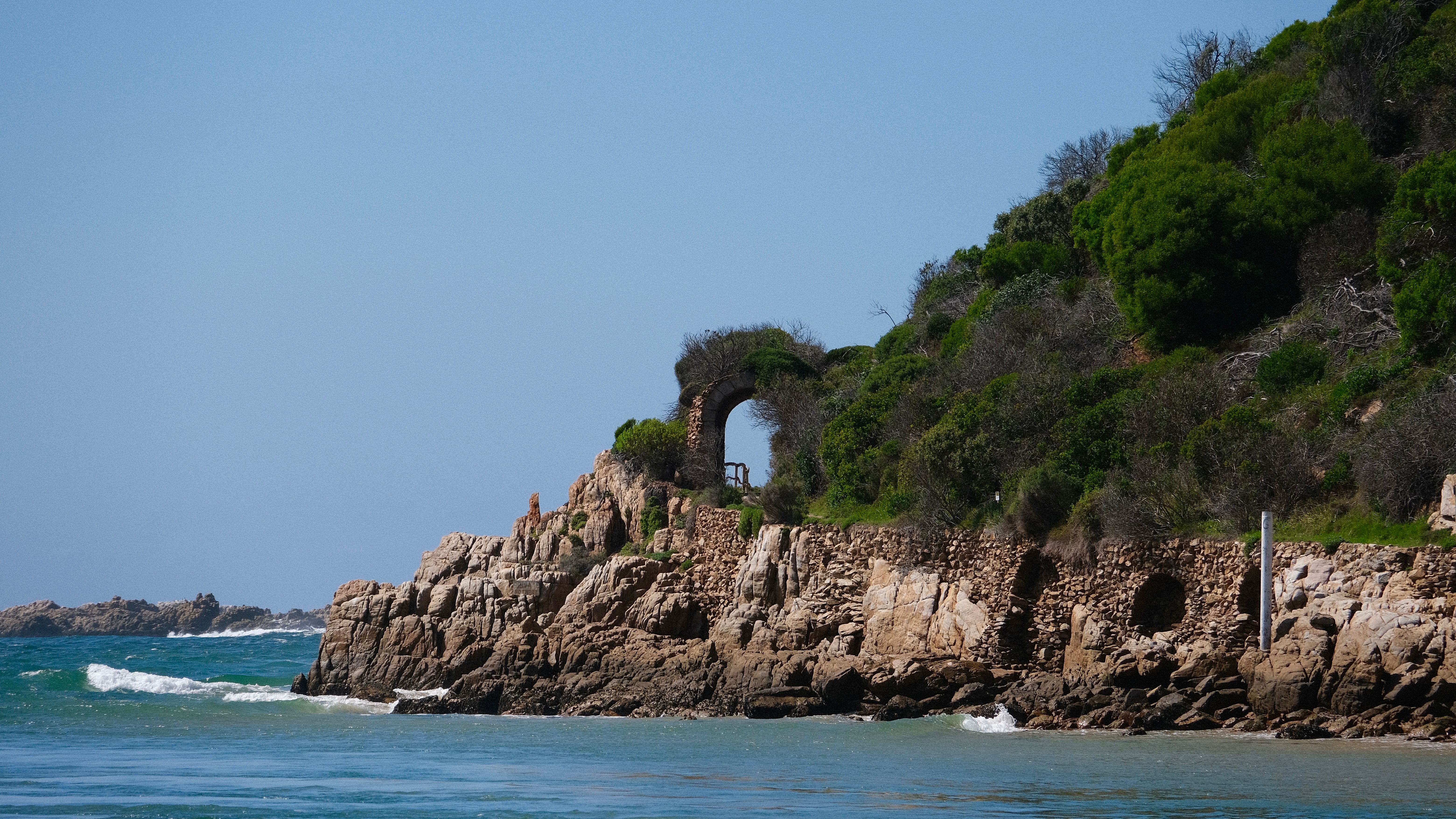 Scenic Coastal Cliff with Ancient Archway · Free Stock Photo