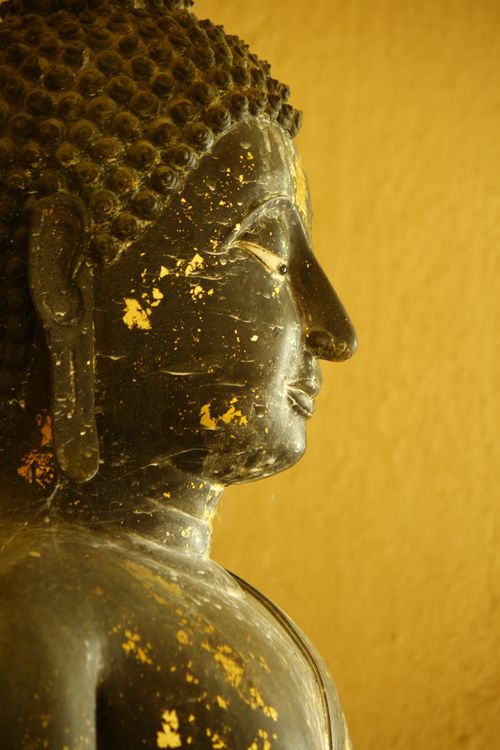 Close-Up of Buddha Statue with Textured Surface · Free Stock Photo