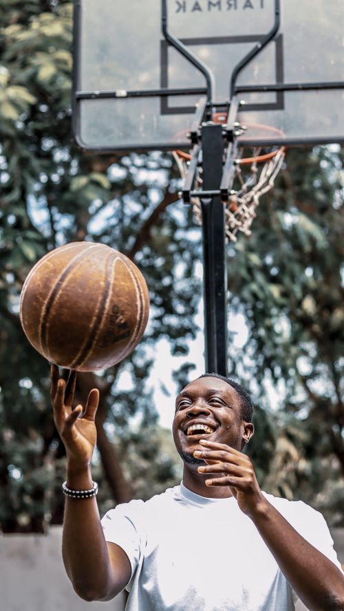 Free A young man enjoying playing basketball on a sunny day in Accra, Ghana. Stock Photo