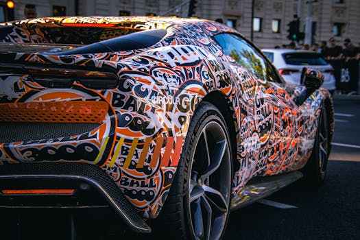 Dynamic image of a sports car with a vibrant graffiti-style wrap, captured on a bustling city street.