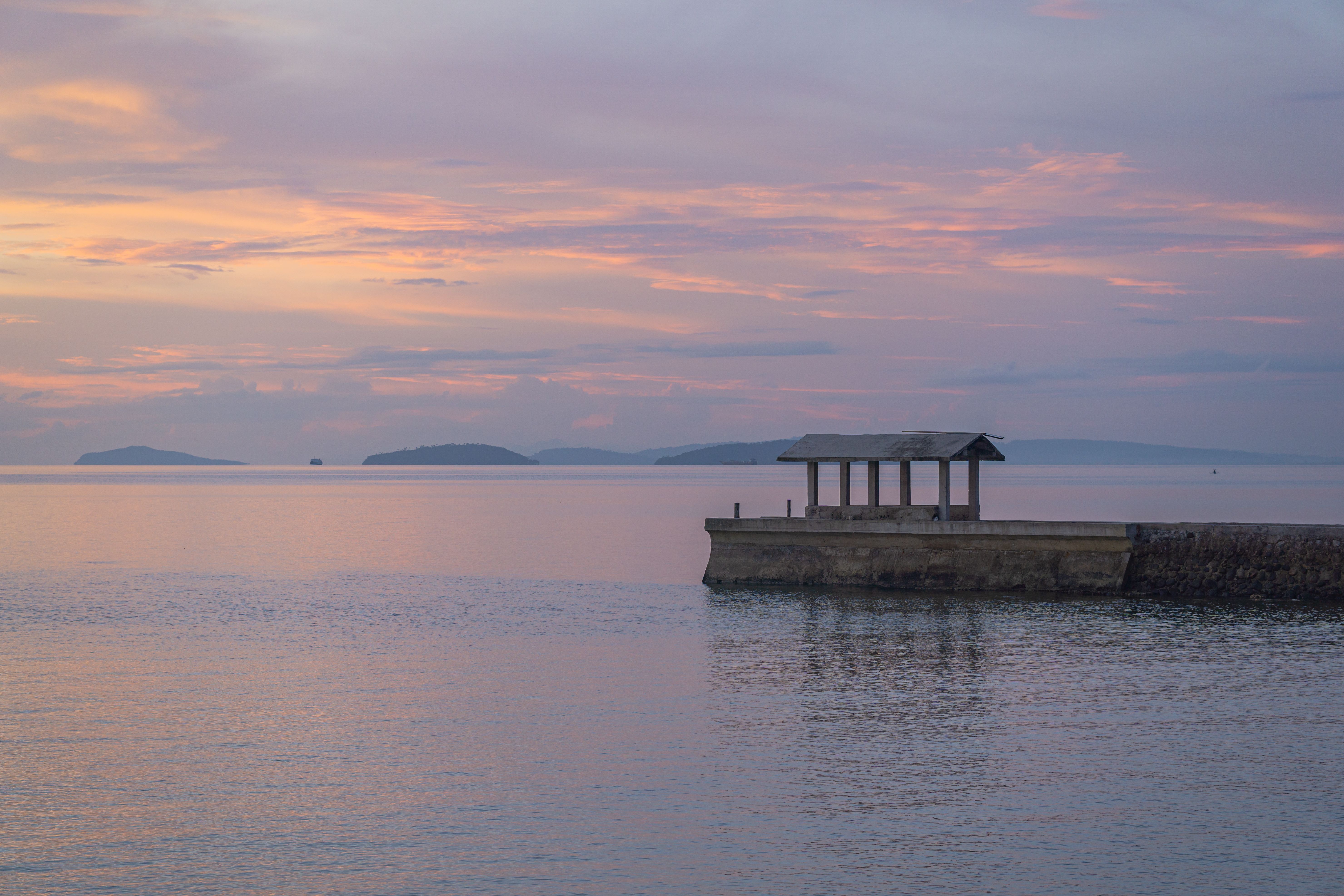 Serene Sunset Over Tranquil Ocean Pier · Free Stock Photo