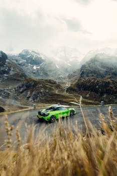 A striking green supercar parked on an alpine pass in Switzerland.