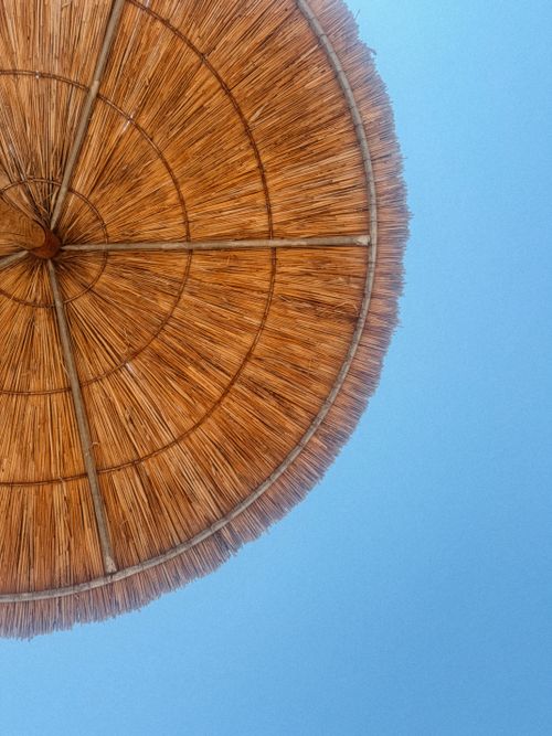 Free Wicker beach umbrella with clear blue sky in Kemer, Antalya, Turkey. Stock Photo