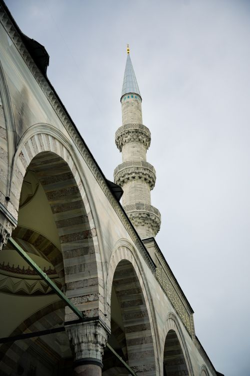 Free View of a mosque minaret with arch details, showcasing Islamic architecture. Stock Photo