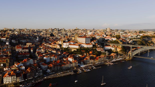 Stunning aerial view of Porto, Portugal at sunset, featuring the iconic Douro River.