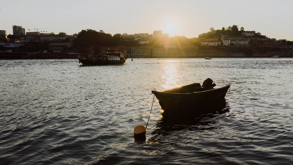 A sunset over the Douro River, highlighting the beauty of Vila Nova de Gaia.