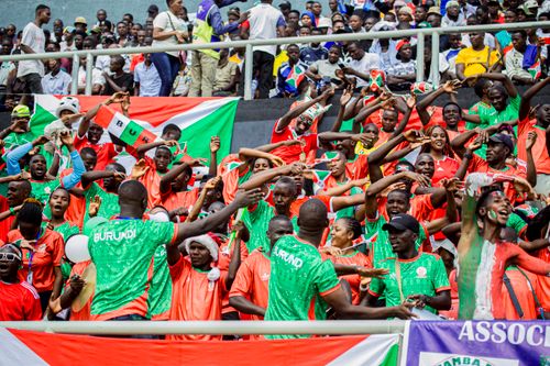 Free Colorful crowd with Burundi flags cheering enthusiastically at a sports event. Stock Photo