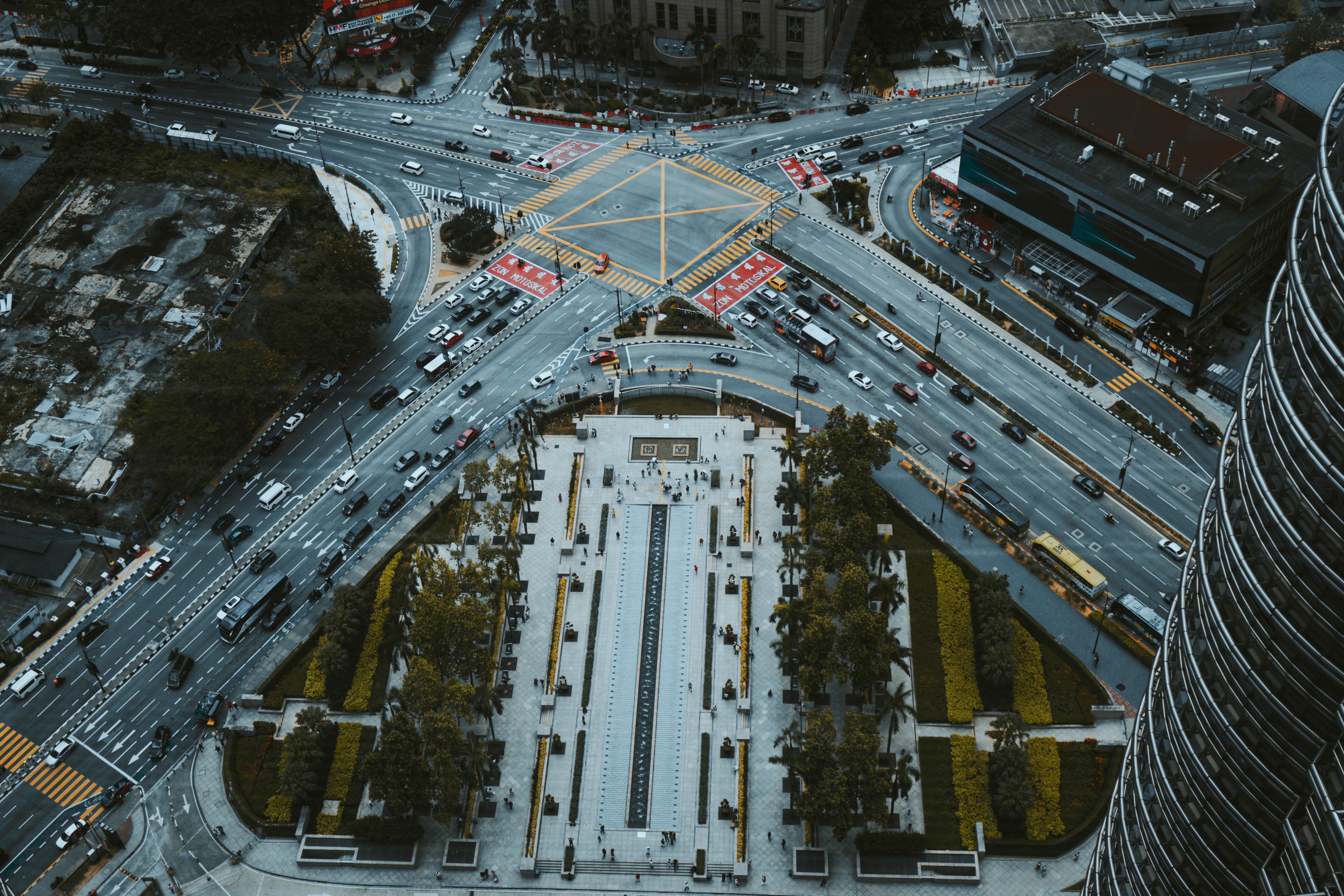 Free Aerial photograph capturing busy intersection in Kuala Lumpur, highlighting modern urban architecture at night. Stock Photo