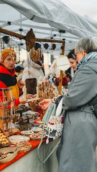 Bustling market scene with shoppers browsing handmade crafts outdoors.