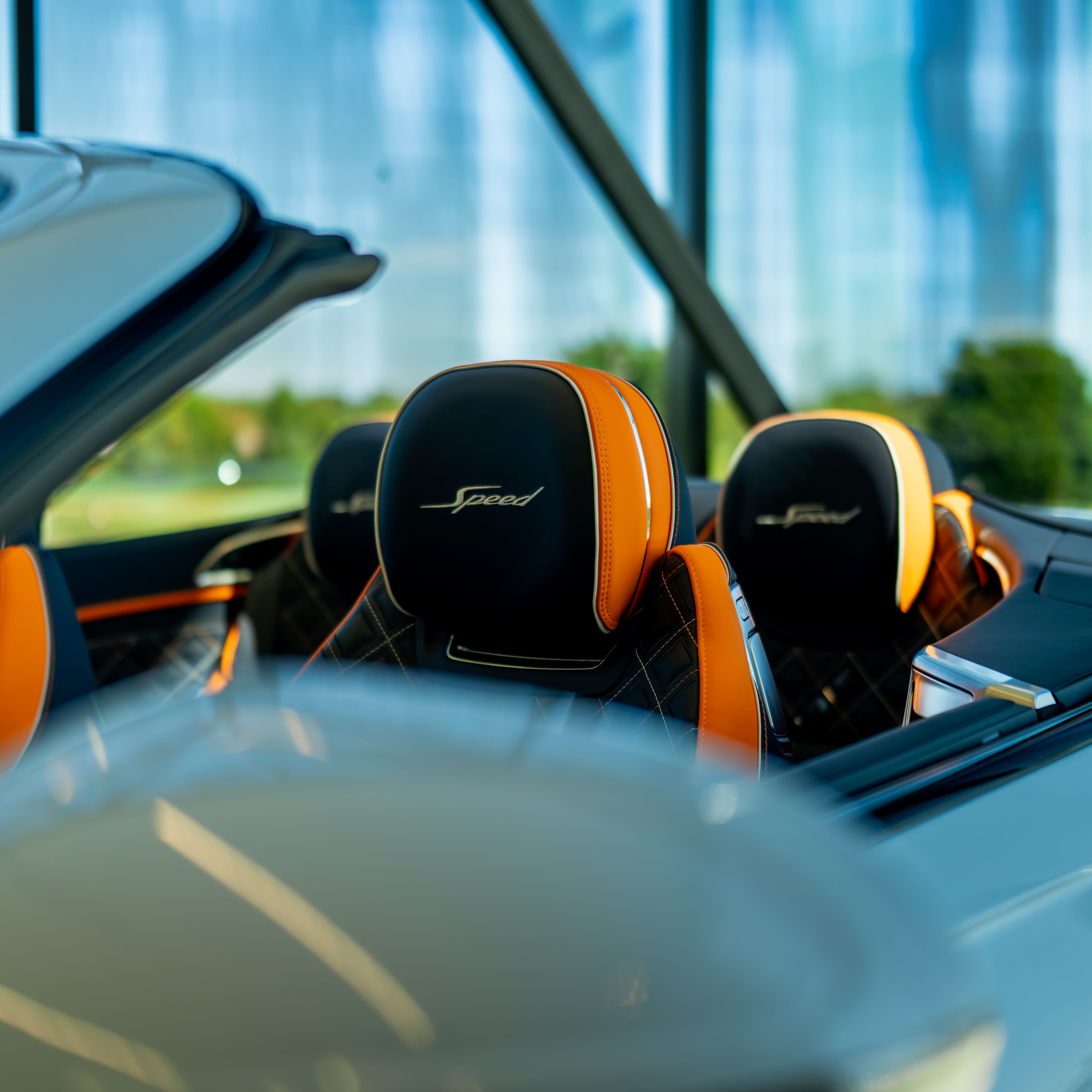 High-end convertible car interior featuring orange accents and luxury leather seats perfect for a modern lifestyle.