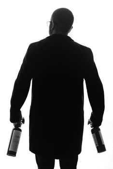 Elegant black and white silhouette of a man holding wine bottles, depicting classic style and sophistication.