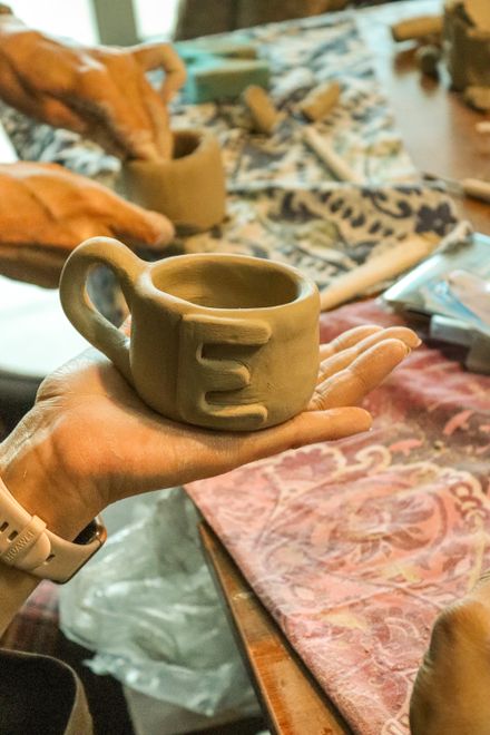 A ceramic mug being shaped by hand in a pottery workshop — photo by Nurgul Kelebek on Pexels